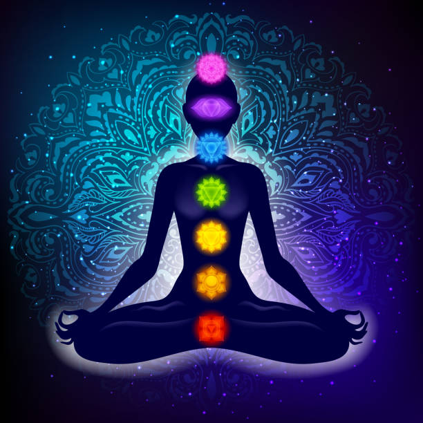 Meditating woman in lotus pose. Yoga illustration. Colorful 7 chakras and aura glow. Mandala background.